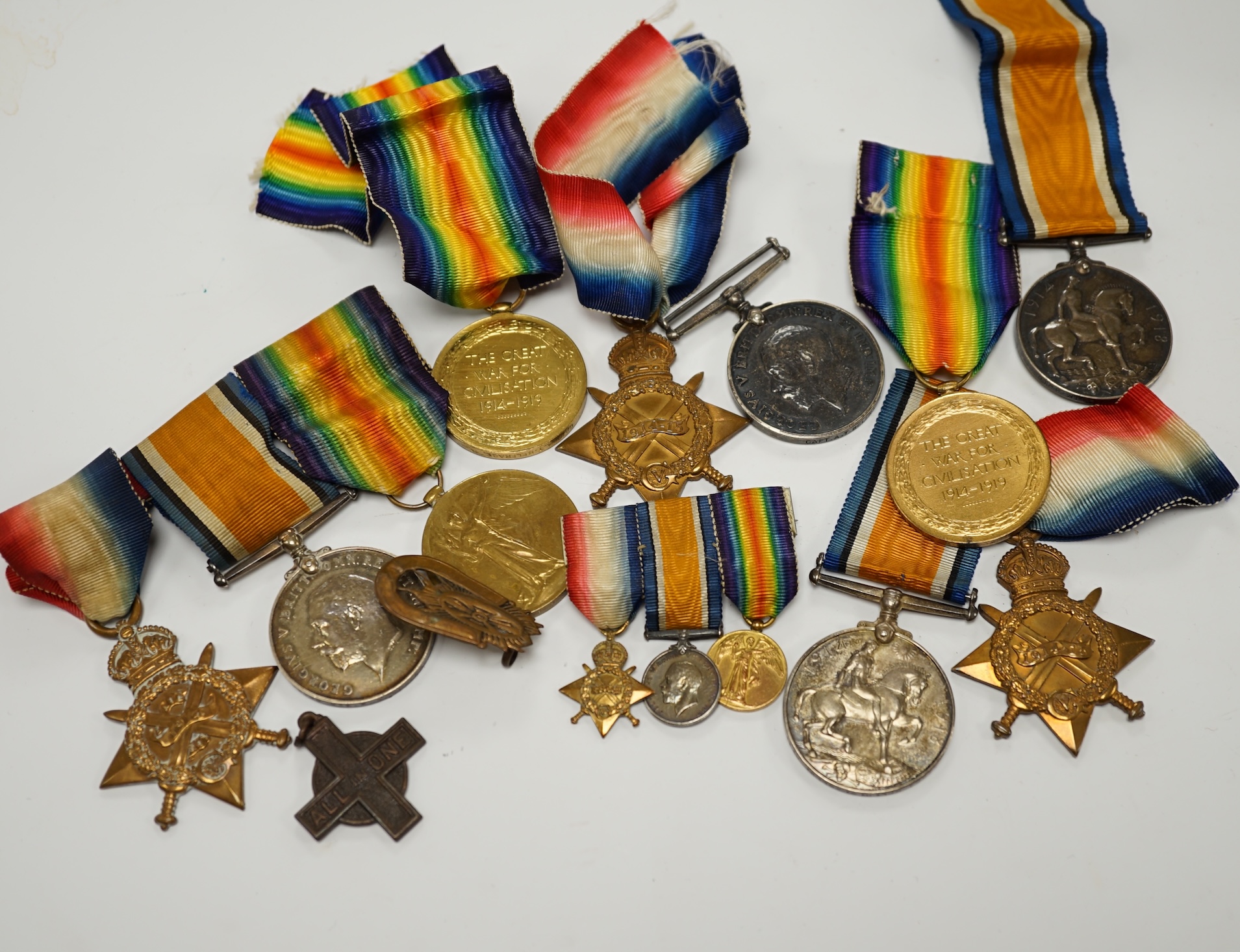 Three First World War medal trios awarded to; Pte. W.C. Belfrage 3rd Canadian MTD Rifles, Cpl. R.W. Wells R.F.A. and Pte. F.G. Walker R.A.M.C. together with two additional British war medals, two miniature metal groups,